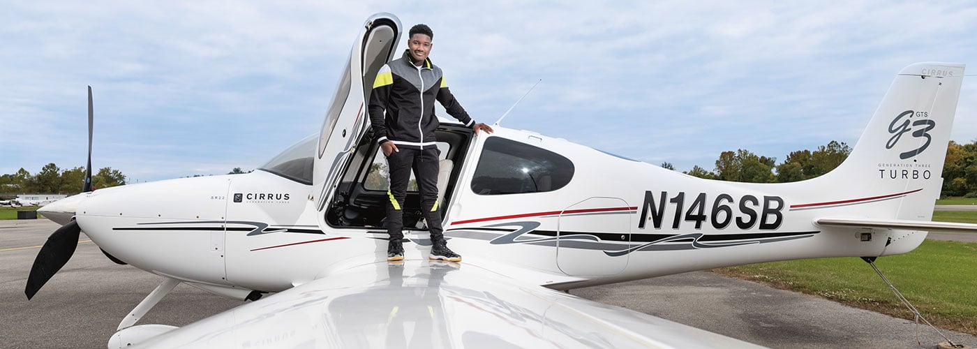 Photo of a person standing on wing of a small plane