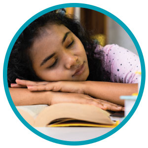 Image of a student sleeping on their book