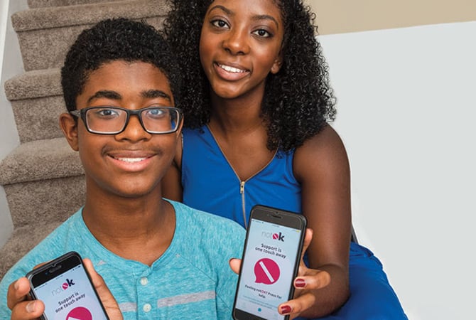 A boy and a girl showing an app on their phones